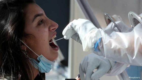 A man collects a swab sample from a woman as he demonstrates operating of the coronavirus disease (COVID-19) checking system, at Ben Gurion International airport in Lod, Israel November 9, 2020. REUTERS/Ammar Awad